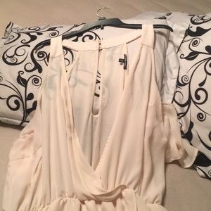 Peachy sleeveless or off shoulder silky dress.